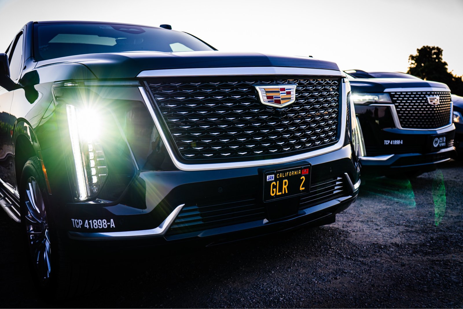 Two late-model Cadillac Escalade ESVs at golden hour with CPUC TCP 41898-A plate, Napa Valley